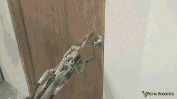Stupid robot tries to open the door handle