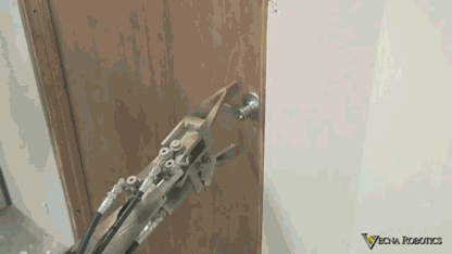 Stupid robot tries to open the door handle